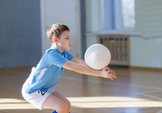 Side View Of Boy Playing Volleyball